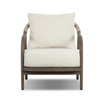 Capturing the ease of tropical ratan seating, an oversized outdoor chair is shaped from FSC-certified teak and wrapped with rush cord detailing. Exemplary woodworking is seen in the fluid lines that end with sturdy spindle legs supporting the comfortable S-spring fixed seat and loose cushion, upholstered in taupe burlap fabric. Amethyst Home provides interior design, new home construction design consulting, vintage area rugs, and lighting in the Newport Beach metro area.