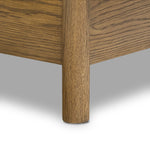 Rounded, chunky dowel legs in an amber oak finish frame the tan top-grain leather headboard of this simple-but-striking bed frame Amethyst Home provides interior design, new home construction design consulting, vintage area rugs, and lighting in the Miami metro area.