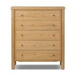 Create storage space in the bedroom with a five-drawer dresser of amber-finished oak. Chunky dowel legs support a tall silhouette and overhang top, all finished out with simple gunmetal hardware Amethyst Home provides interior design, new home construction design consulting, vintage area rugs, and lighting in the Austin metro area.