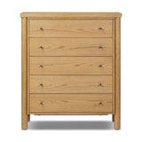 Create storage space in the bedroom with a five-drawer dresser of amber-finished oak. Chunky dowel legs support a tall silhouette and overhang top, all finished out with simple gunmetal hardware Amethyst Home provides interior design, new home construction design consulting, vintage area rugs, and lighting in the Austin metro area.