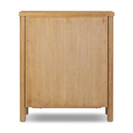 Create storage space in the bedroom with a five-drawer dresser of amber-finished oak. Chunky dowel legs support a tall silhouette and overhang top, all finished out with simple gunmetal hardware Amethyst Home provides interior design, new home construction design consulting, vintage area rugs, and lighting in the Tampa metro area.