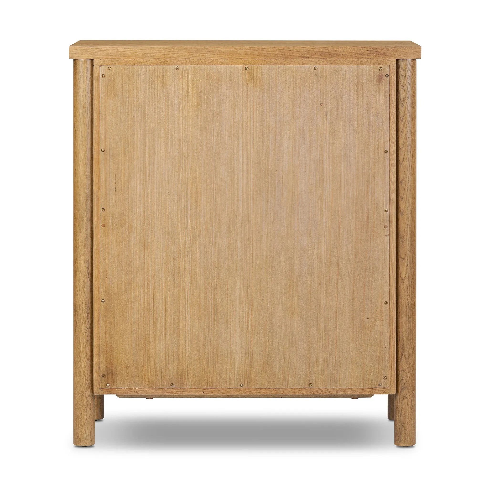Create storage space in the bedroom with a five-drawer dresser of amber-finished oak. Chunky dowel legs support a tall silhouette and overhang top, all finished out with simple gunmetal hardware Amethyst Home provides interior design, new home construction design consulting, vintage area rugs, and lighting in the Tampa metro area.