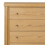 Create storage space in the bedroom with a five-drawer dresser of amber-finished oak. Chunky dowel legs support a tall silhouette and overhang top, all finished out with simple gunmetal hardware Amethyst Home provides interior design, new home construction design consulting, vintage area rugs, and lighting in the Washington metro area.