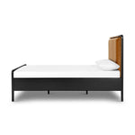 Ebony-finished oak frames a sling-style headboard made from top-grain leather, with subtly rounded edges and metal dowel detailing Amethyst Home provides interior design, new home construction design consulting, vintage area rugs, and lighting in the Des Moines metro area.