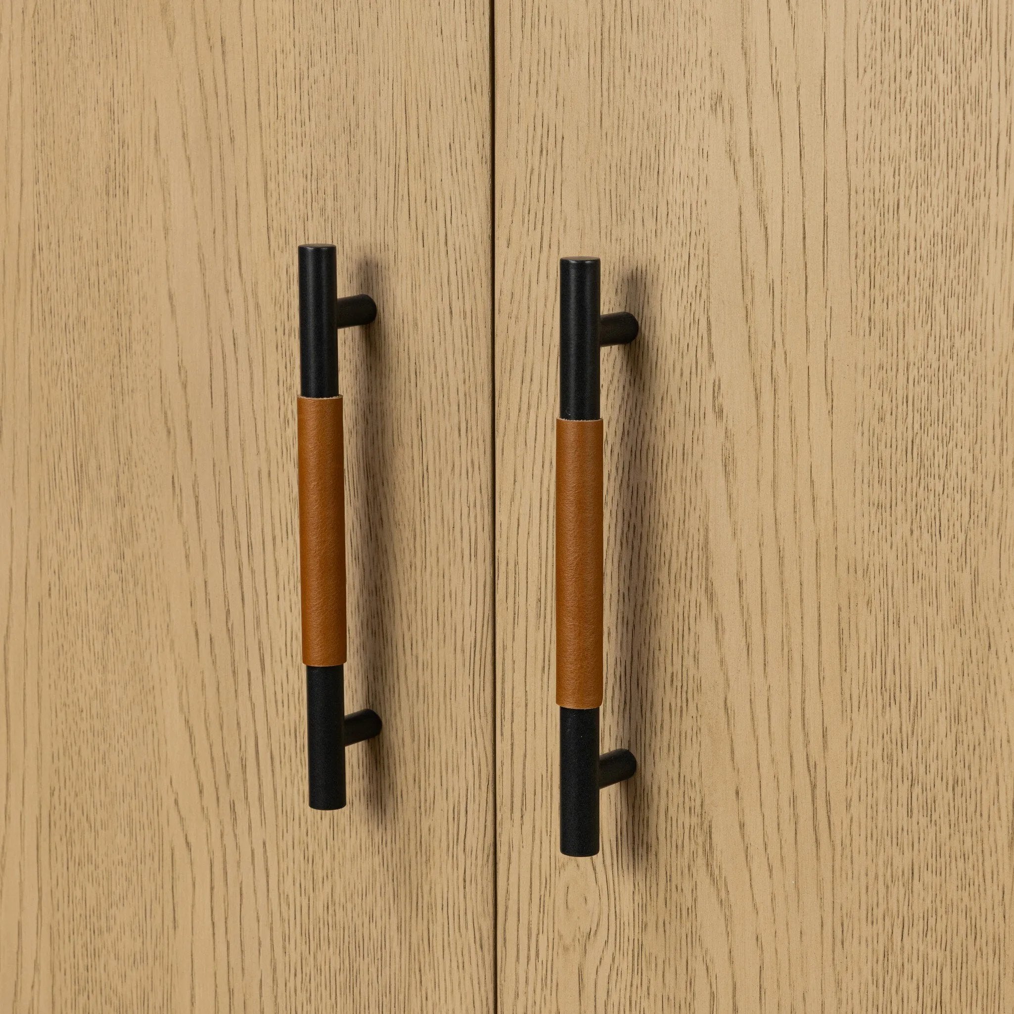 Accented with iron hardware wrapped in tan top-grain leather, light-finished oak veneer forms a clean silhouette with plenty of storage. Outset legs add an element of interest.As fans of wabi sabi materials at Amethyst, we love the optimistic inspired Rosedale Cabinet - Yucca Oak Veneer. Amethyst Home provides interior design, new home construction design consulting, vintage area rugs, and lighting in the Los Angeles metro area.