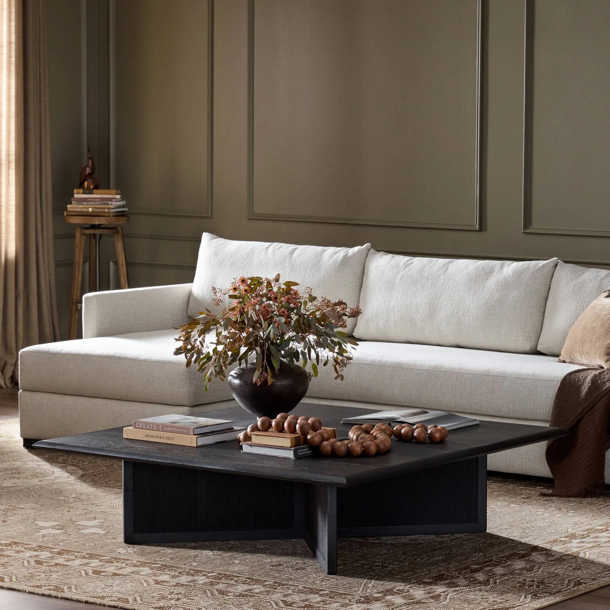 Anchor your living space with a squared coffee table of black-finished oak. A smooth top pairs with a panel-style base of woven paper cord for a rich, clean look that will work into your collection beautifully Amethyst Home provides interior design, new home construction design consulting, vintage area rugs, and lighting in the Newport Beach metro area.