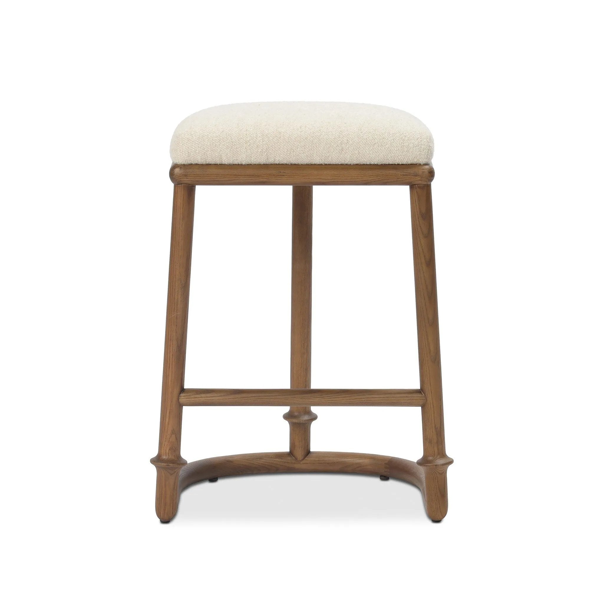 A simple backless stool pairs antique walnut-finished solid ash and high-performance fabric, for a warm, light look. A backless cylinder frame featured tapering for extra stability, with disc-like turning at the bottom for a heritage design detail. Perfectly sized for the counter. Amethyst Home provides interior design, new home construction design consulting, vintage area rugs, and lighting in the Houston metro area.
