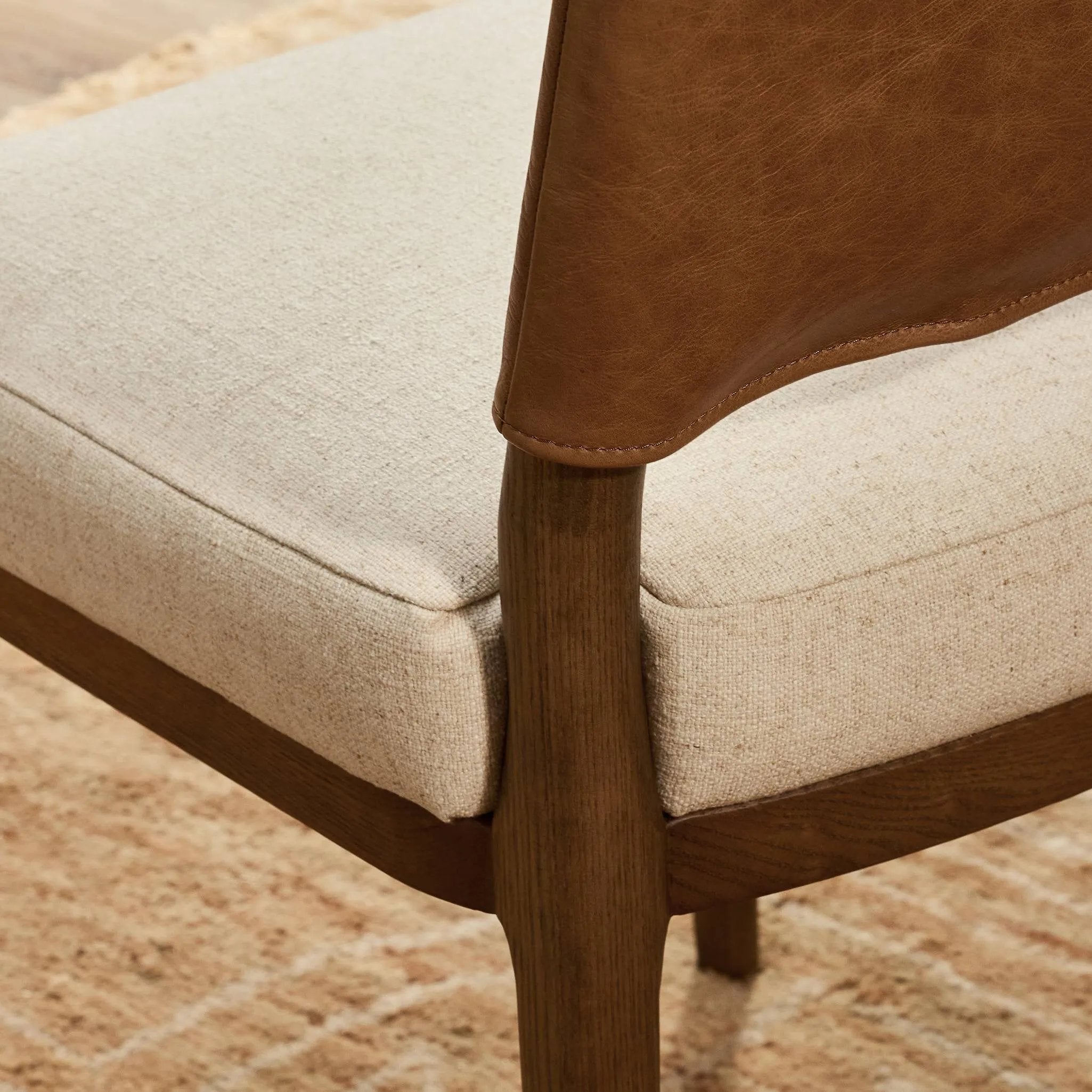 The classic material mix look you want in your dining space. Butterscotch top-grain leather with a subtle vintage look pairs with a neutral performance fabric-upholstered seat. Tapered legs and an armless silhouette look timelessly chic. Amethyst Home provides interior design, new home construction design consulting, vintage area rugs, and lighting in the Miami metro area.