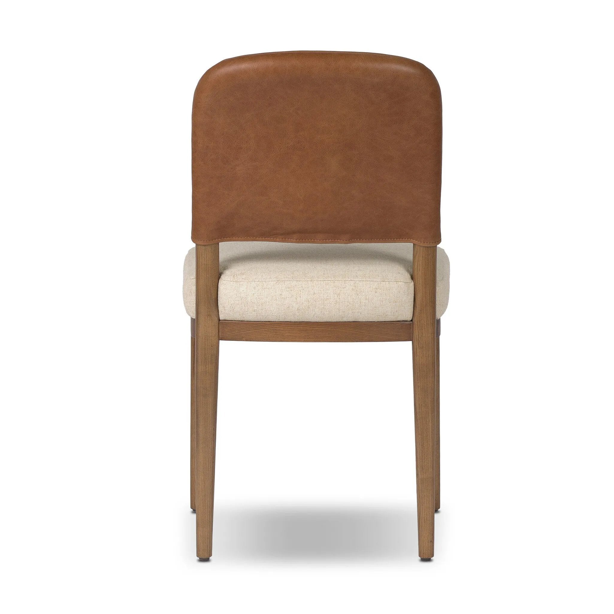 The classic material mix look you want in your dining space. Butterscotch top-grain leather with a subtle vintage look pairs with a neutral performance fabric-upholstered seat. Tapered legs and an armless silhouette look timelessly chic. Amethyst Home provides interior design, new home construction design consulting, vintage area rugs, and lighting in the Salt Lake City metro area.