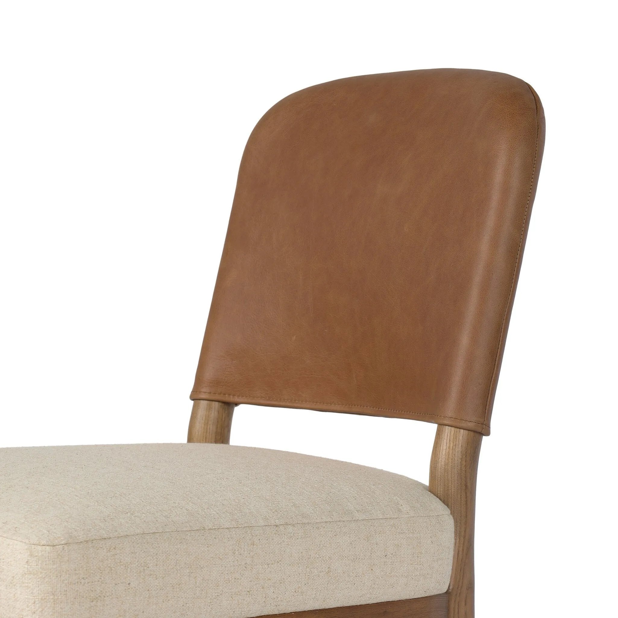 The classic material mix look you want in your dining space. Butterscotch top-grain leather with a subtle vintage look pairs with a neutral performance fabric-upholstered seat. Tapered legs and an armless silhouette look timelessly chic. Amethyst Home provides interior design, new home construction design consulting, vintage area rugs, and lighting in the Washington metro area.