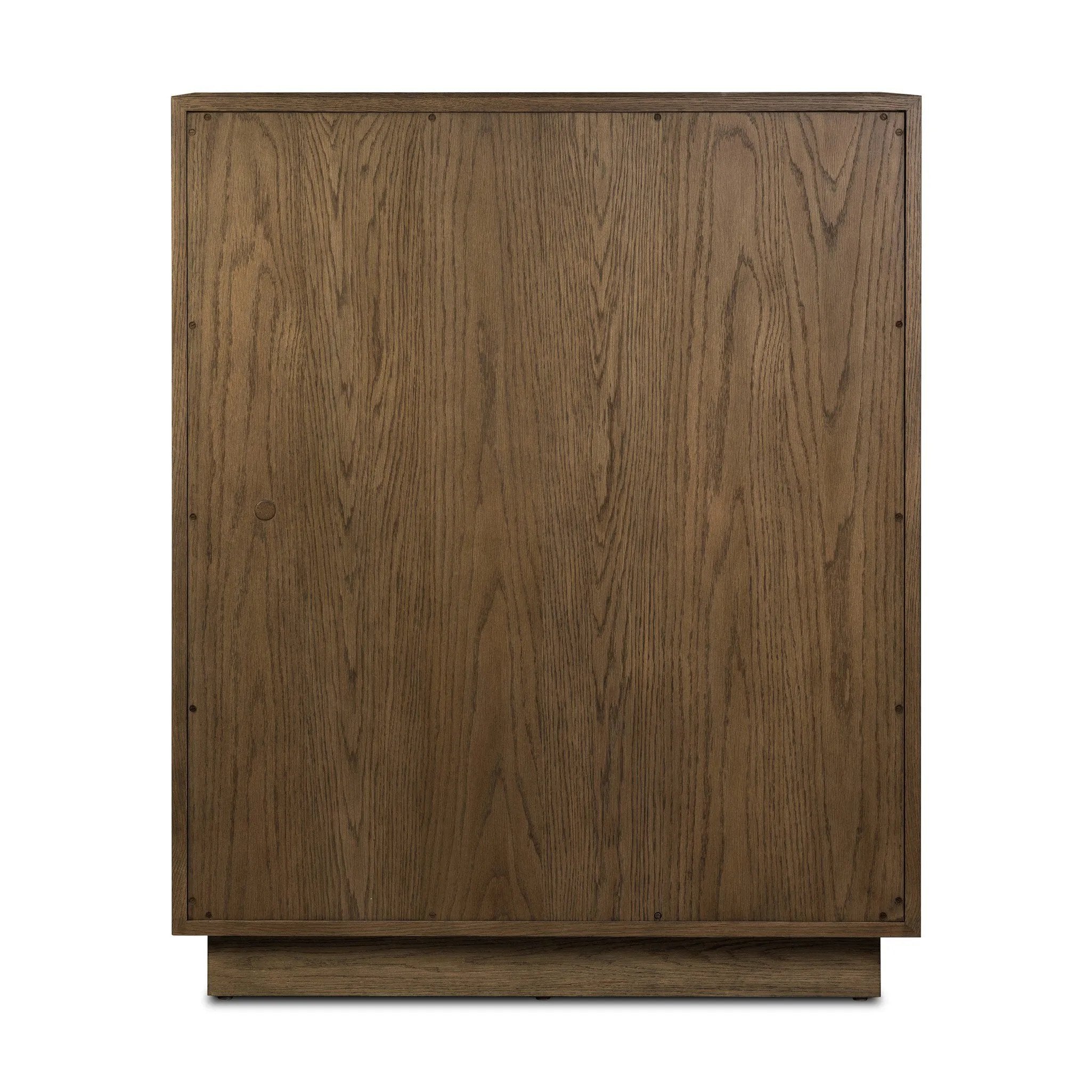 Grounding and stunning. We paired a modern frame and chunky base with door panels featuring oyster cuts of oak that take a specialized skill to create. Each cut captures the story of the wood and brings a natural, organic rhythm to the entire cabinet, and any space. Amethyst Home provides interior design, new home construction design consulting, vintage area rugs, and lighting in the Dallas metro area.