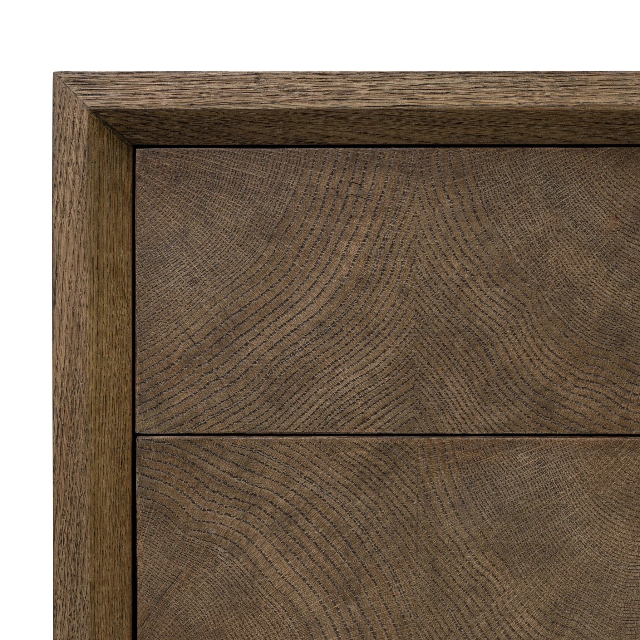 Influenced by contemporary design, this nightstand’s simple frame showcases thick brown oak veneer with a tiled oyster cut pattern on the insert panels. Three drawers with minimalist metal pulls offer ample space for bedside essentials. Amethyst Home provides interior design, new home construction design consulting, vintage area rugs, and lighting in the Austin metro area.