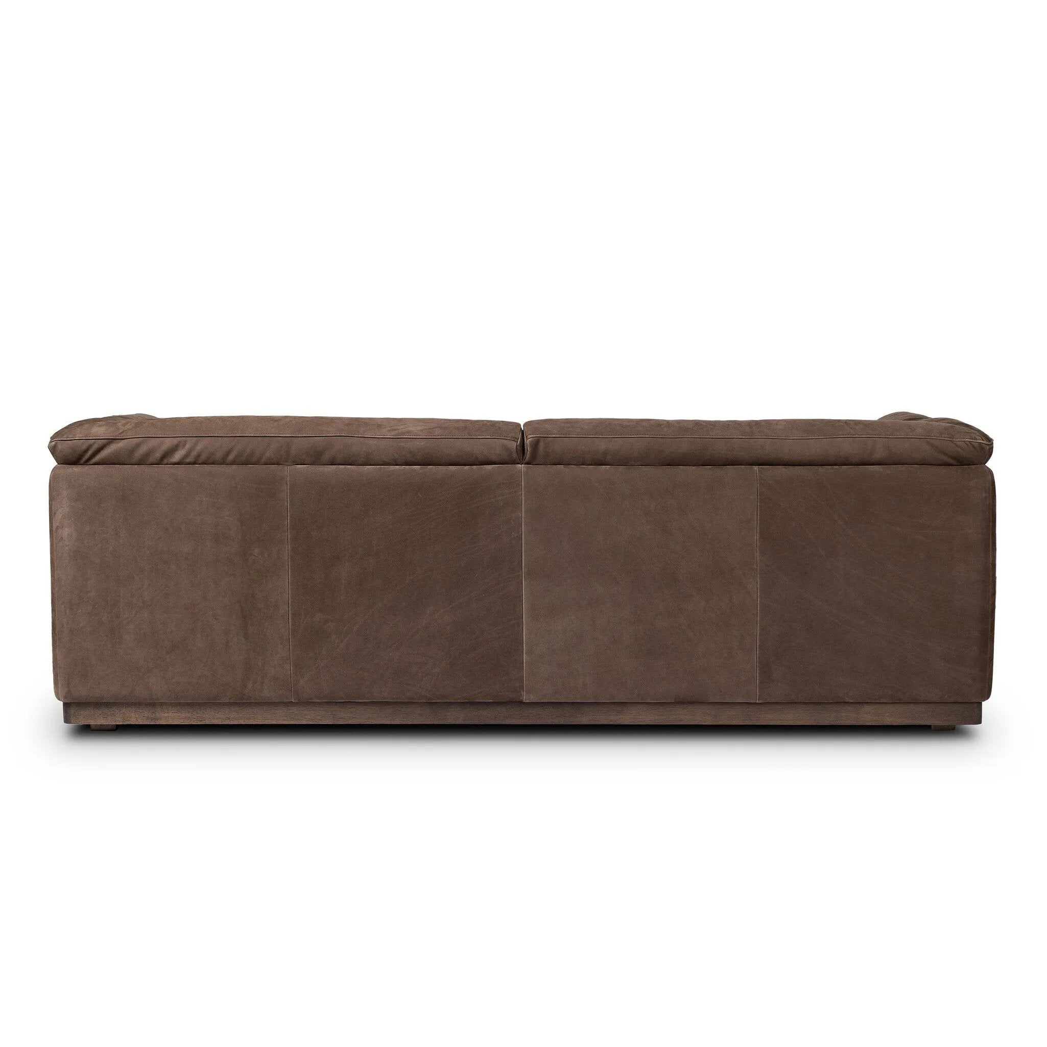 Inspired by 1970s Brutalism, this urban tuxedo sofa balances a rounded solid wood plinth with a curved seat deck and a relaxed, "wrinkled" upholstery design. Feather-blend cushions wrap the frame, finished with dramatic blind tufting for a hand-crafted, textural edge. Amethyst Home provides interior design, new home construction design consulting, vintage area rugs, and lighting in the Boston metro area.