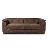 Inspired by 1970s Brutalism, this urban tuxedo sofa balances a rounded solid wood plinth with a curved seat deck and a relaxed, "wrinkled" upholstery design. Feather-blend cushions wrap the frame, finished with dramatic blind tufting for a hand-crafted, textural edge. Amethyst Home provides interior design, new home construction design consulting, vintage area rugs, and lighting in the Houston metro area.