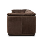 Inspired by 1970s Brutalism, this urban tuxedo sofa balances a rounded solid wood plinth with a curved seat deck and a relaxed, "wrinkled" upholstery design. Feather-blend cushions wrap the frame, finished with dramatic blind tufting for a hand-crafted, textural edge. Amethyst Home provides interior design, new home construction design consulting, vintage area rugs, and lighting in the Miami metro area.
