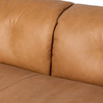 Inspired by 1970s Brutalism, this urban tuxedo sofa balances a rounded solid wood plinth with a curved seat deck and a relaxed, "wrinkled" upholstery design. Feather-blend cushions wrap the frame, finished with dramatic blind tufting for a hand-crafted, textural edge. Amethyst Home provides interior design, new home construction design consulting, vintage area rugs, and lighting in the Dallas metro area.
