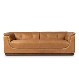 Inspired by 1970s Brutalism, this urban tuxedo sofa balances a rounded solid wood plinth with a curved seat deck and a relaxed, "wrinkled" upholstery design. Feather-blend cushions wrap the frame, finished with dramatic blind tufting for a hand-crafted, textural edge. Amethyst Home provides interior design, new home construction design consulting, vintage area rugs, and lighting in the Houston metro area.