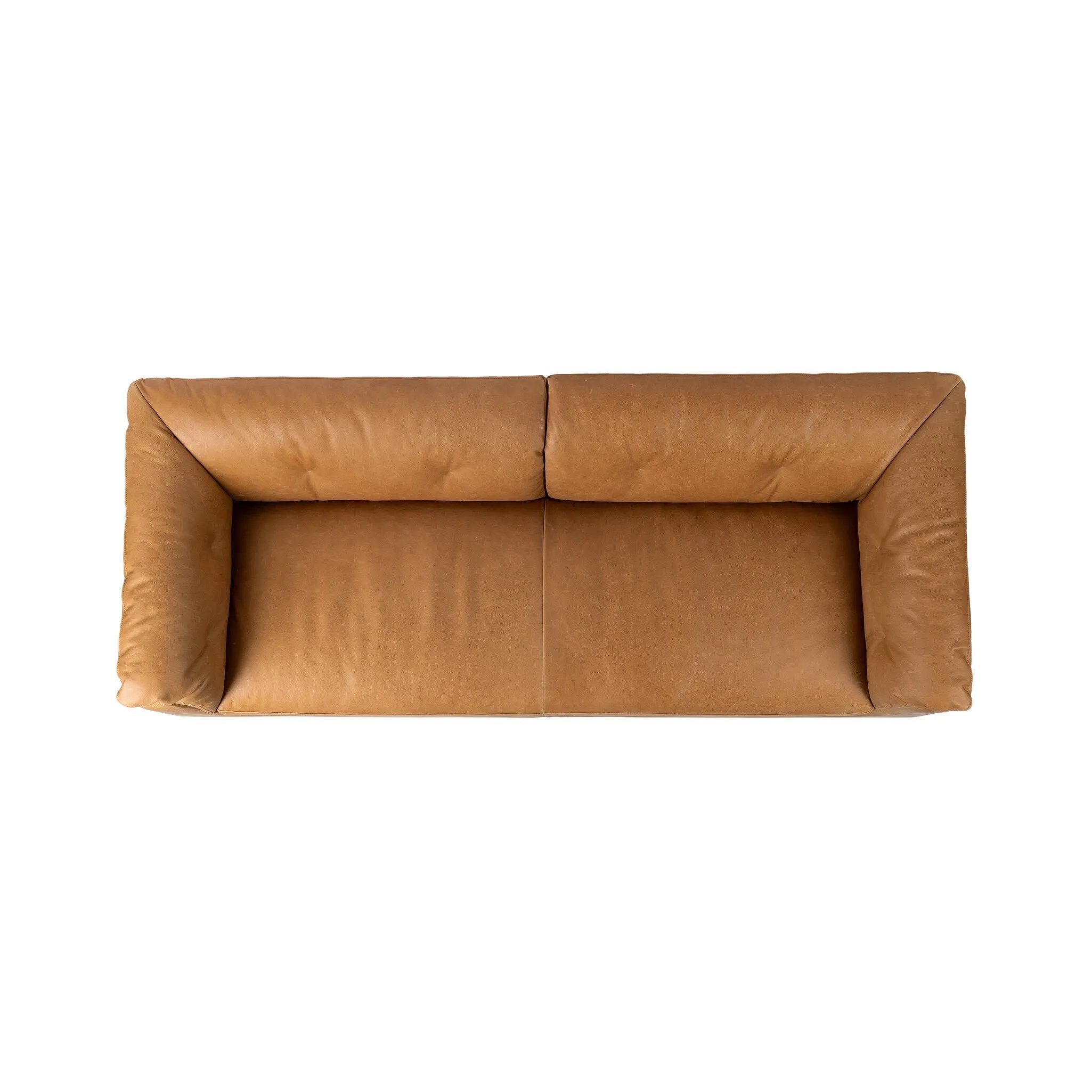 Inspired by 1970s Brutalism, this urban tuxedo sofa balances a rounded solid wood plinth with a curved seat deck and a relaxed, "wrinkled" upholstery design. Feather-blend cushions wrap the frame, finished with dramatic blind tufting for a hand-crafted, textural edge. Amethyst Home provides interior design, new home construction design consulting, vintage area rugs, and lighting in the Salt Lake City metro area.