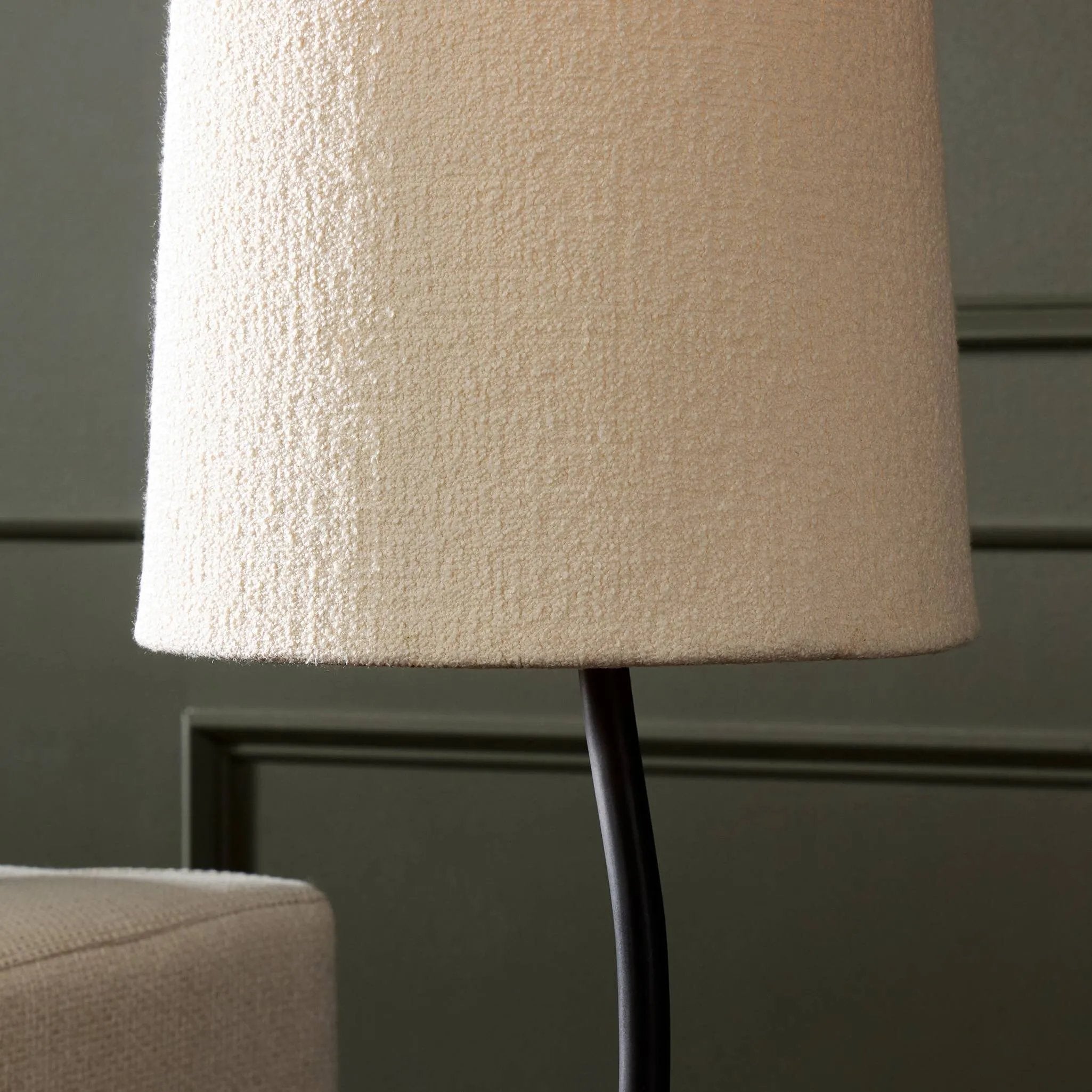 Featuring Selby Black Wrought Iron Floor Lamp by Four Hands at Amethyst Home. A curved cast iron tripod base pairs with an elongated boucle shade for a sculpted, minimalist look that works into any room with ease. Overall Dimensions: 12.75"w x 12.75"d x 60.00"h. Amethyst Home provides interior design, new home construction design consulting, vintage area rugs, and lighting in the Salt Lake City metro area.