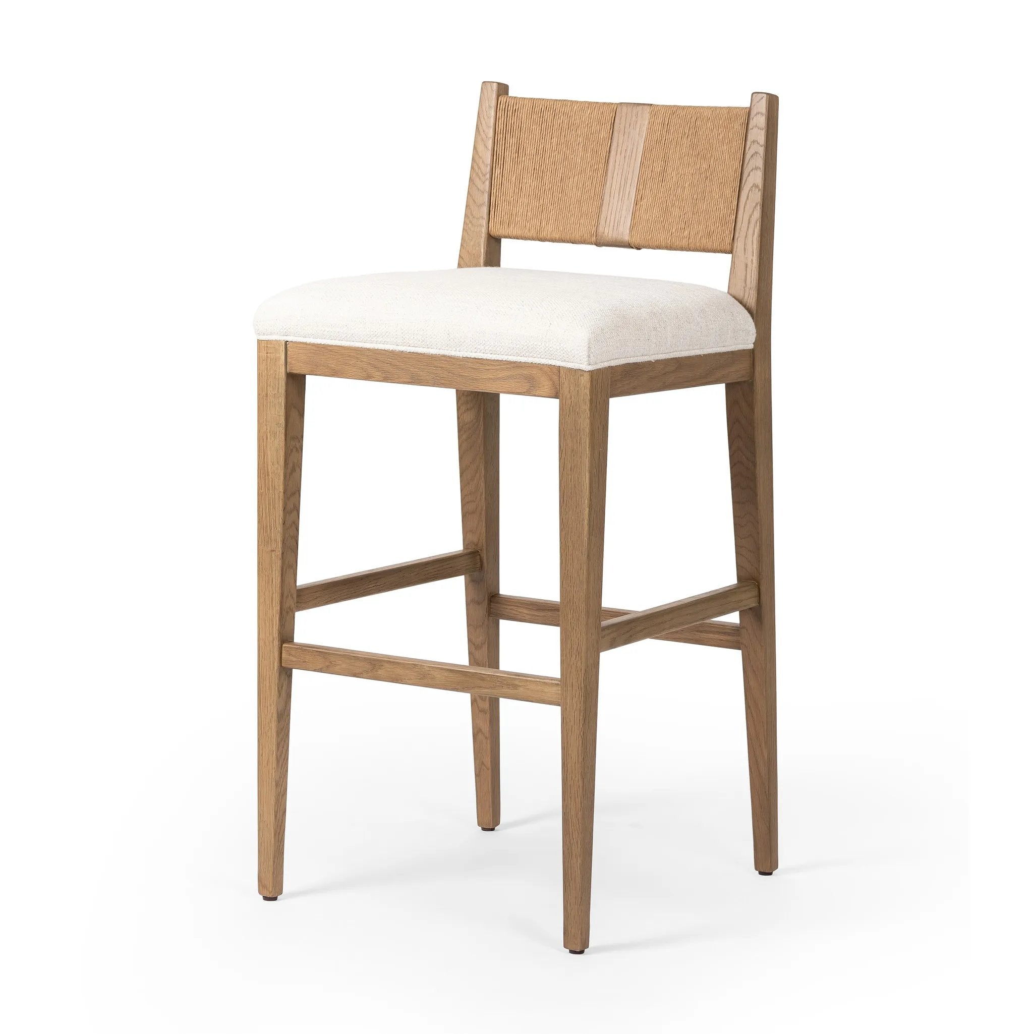 Unique materials make this bar stool a standout. A low, perfectly pitched backrest is made from wrapped paper cord and aged oak, for a natural, textured look. Simple squared seating is upholstered in high-performance fabric, perfect for entertaining. Amethyst Home provides interior design, new home construction design consulting, vintage area rugs, and lighting in the Calabasas metro area.