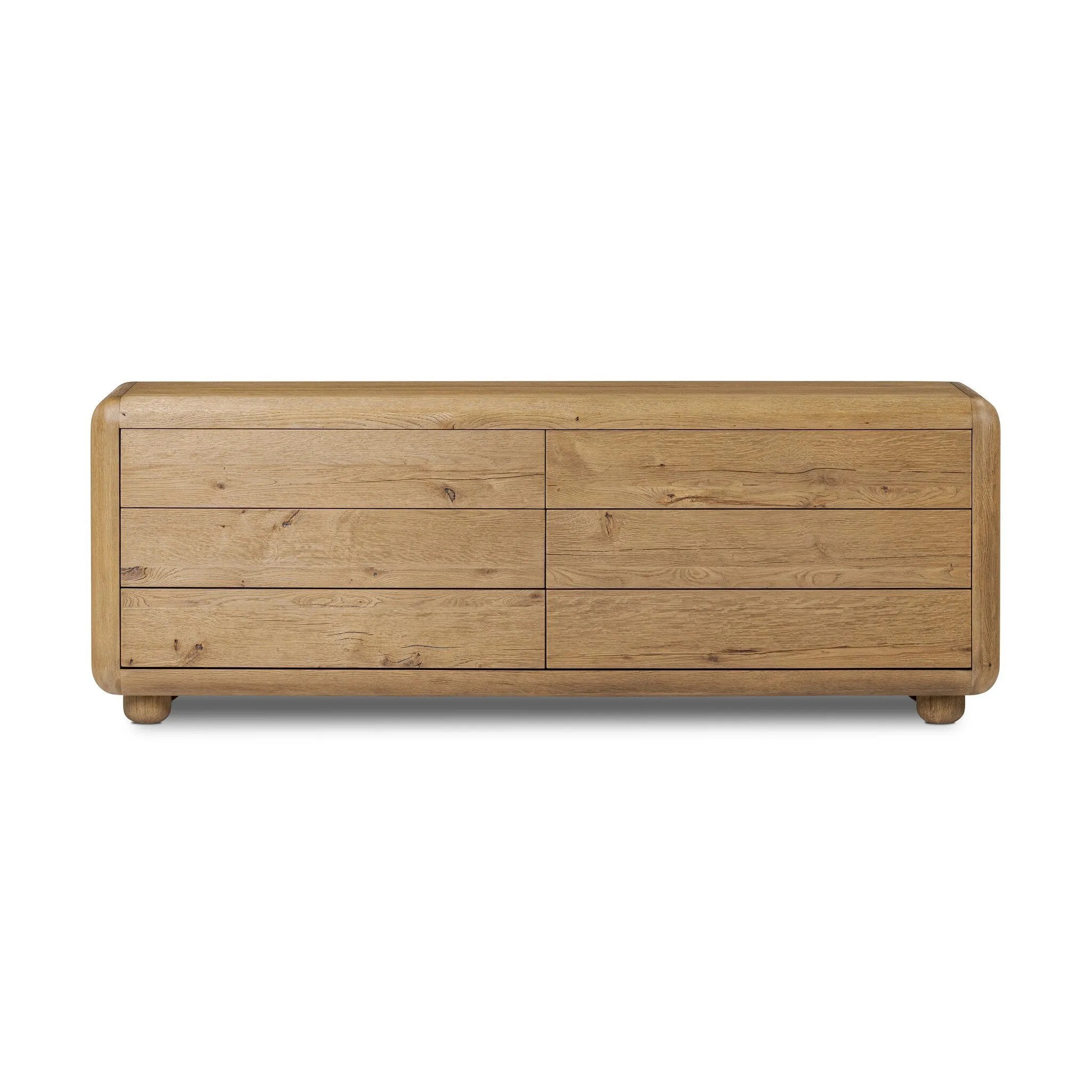 Blending modern design with classic features, this dresser is at once soft and bold. Set low to the ground on rounded feet, the dresser has prominent rounded corners that emphasize its smooth finish. Crafted from solid warm oak and veneers with push-latch hardware for a clean front Amethyst Home provides interior design, new home construction design consulting, vintage area rugs, and lighting in the Houston metro area.