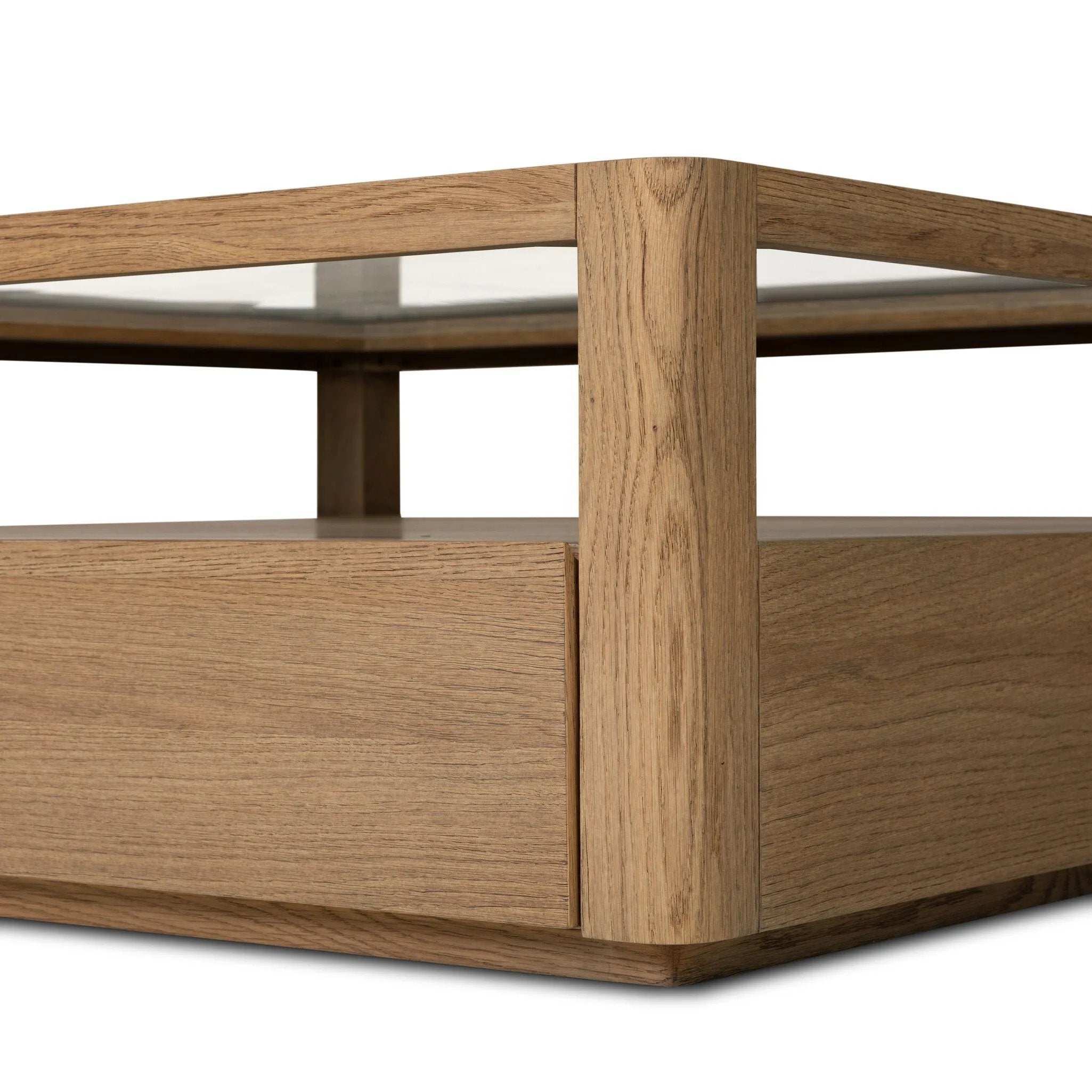 Bring bonus storage and a light look to the living space. Made from sandy oak and clear tempered glass with two roomy drawers on either side of the base, plus shelving beneath the glass that doubles as a shadowbox or an extra display surface.As lovers of luxe design at Amethyst, we love the warm modern inspired Shiloh Coffee Table - Tempered Glass. Amethyst Home provides interior design, new home construction design consulting, vintage area rugs, and lighting in the Tampa metro area.