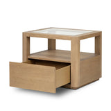 Bring bonus storage and a light look to the living space. Made from sandy oak and clear tempered glass with a single drawer, shelving beneath the glass doubles as a shadowbox or an extra display surface.As lovers of clean materials at Amethyst, we love the designer inspired Shiloh End Table - Tempered Glass. Amethyst Home provides interior design, new home construction design consulting, vintage area rugs, and lighting in the Dallas metro area.