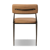 Bring a slim, light look to the dining room. This dining chair pairs camel top-grain leather and bronzed iron to craft a simple, airy look. A tapered leg and decorative handle on the back elevate the look.As enthusiasts of natural materials at Amethyst, we love the warm modern inspired Somerson Dining Chair - Maestro Camel. Amethyst Home provides interior design, new home construction design consulting, vintage area rugs, and lighting in the Kansas City metro area.