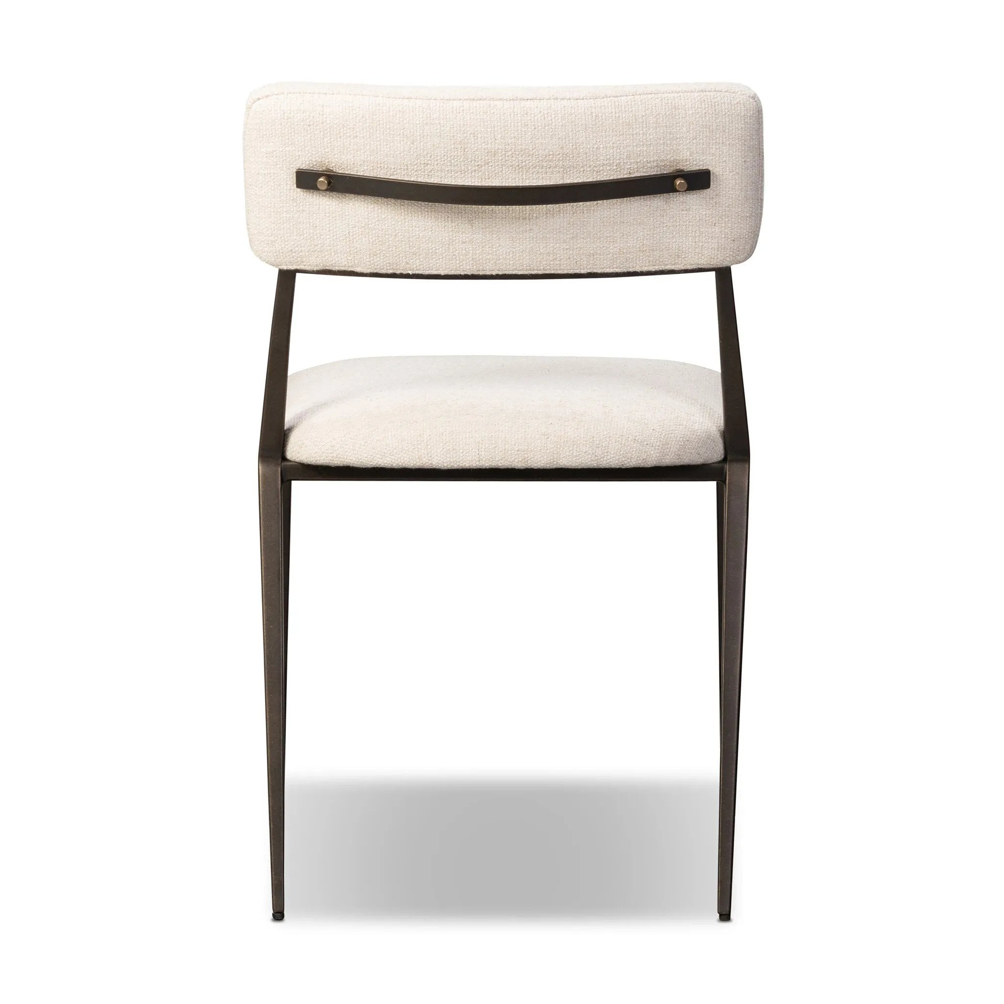 Bring a slim, light look to the dining room. This dining chair pairs cream performance fabric exclusive to Four Hands and bronzed iron to craft a simple, airy look. A tapered leg and decorative handle on the back elevate the look. Amethyst Home provides interior design, new home construction design consulting, vintage area rugs, and lighting in the Boston metro area.