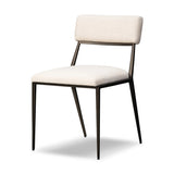 Bring a slim, light look to the dining room. This dining chair pairs cream performance fabric exclusive to Four Hands and bronzed iron to craft a simple, airy look. A tapered leg and decorative handle on the back elevate the look. Amethyst Home provides interior design, new home construction design consulting, vintage area rugs, and lighting in the Washington metro area.