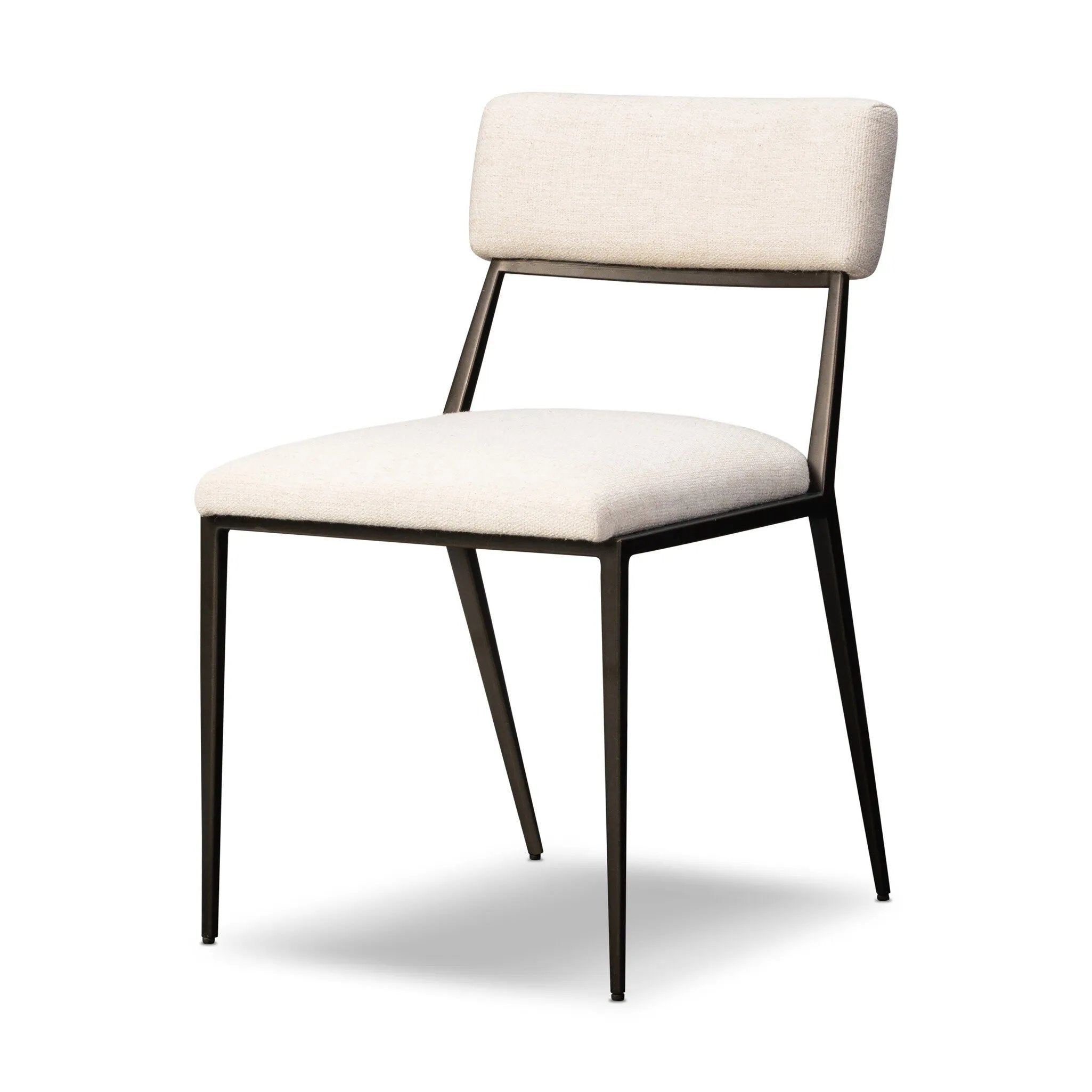 Bring a slim, light look to the dining room. This dining chair pairs cream performance fabric exclusive to Four Hands and bronzed iron to craft a simple, airy look. A tapered leg and decorative handle on the back elevate the look. Amethyst Home provides interior design, new home construction design consulting, vintage area rugs, and lighting in the Washington metro area.