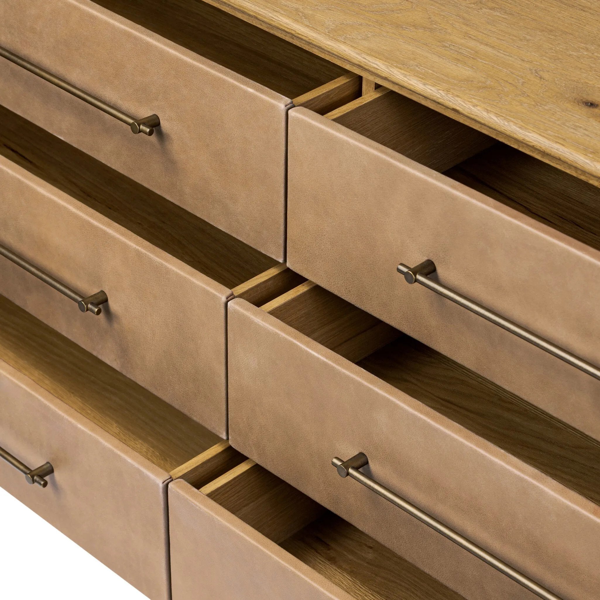 Bring a Nordic, material-driven look to your bedroom with a six-drawer dresser of grain-rich oak and drawer fronts covered with tan top-grain leather. Finished out with long, linear iron hardware Amethyst Home provides interior design, new home construction design consulting, vintage area rugs, and lighting in the Des Moines metro area.