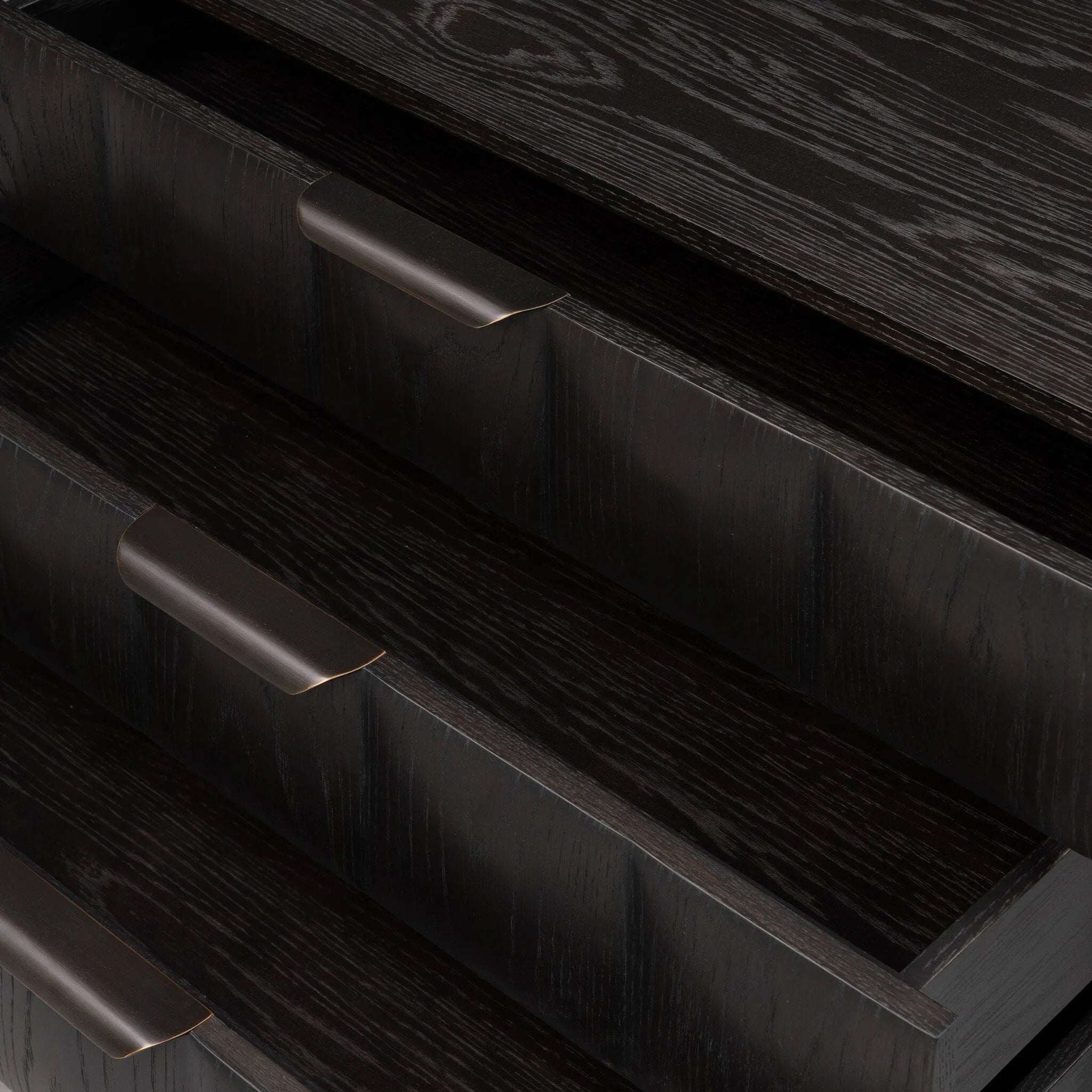 A softened Brutalist take on the traditional nightstand. The monolithic piece’s black oak veneer case sits atop a matching pedestal for an element of exaggeration. A grid pattern with inflated volume adds drama.As enthusiasts of luxe materials at Amethyst, we love the warm modern inspired Swell Nightstand - Dry Black Oak Veneer. Amethyst Home provides interior design, new home construction design consulting, vintage area rugs, and lighting in the Charlotte metro area.