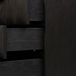 A softened Brutalist take on the traditional nightstand. The monolithic piece’s black oak veneer case sits atop a matching pedestal for an element of exaggeration. A grid pattern with inflated volume adds drama.As enthusiasts of luxe materials at Amethyst, we love the warm modern inspired Swell Nightstand - Dry Black Oak Veneer. Amethyst Home provides interior design, new home construction design consulting, vintage area rugs, and lighting in the Los Angeles metro area.