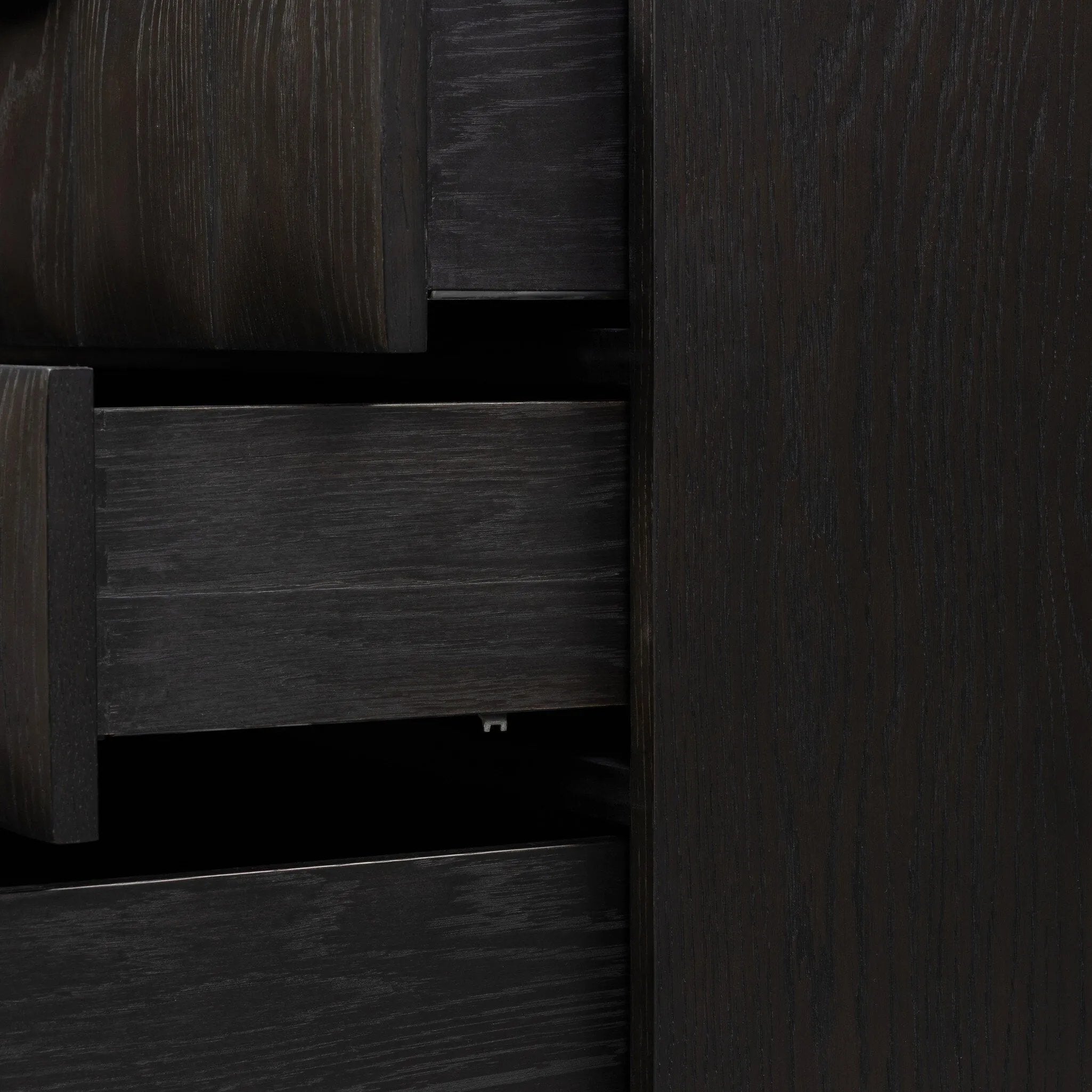 A softened Brutalist take on the traditional nightstand. The monolithic piece’s black oak veneer case sits atop a matching pedestal for an element of exaggeration. A grid pattern with inflated volume adds drama.As enthusiasts of luxe materials at Amethyst, we love the warm modern inspired Swell Nightstand - Dry Black Oak Veneer. Amethyst Home provides interior design, new home construction design consulting, vintage area rugs, and lighting in the Los Angeles metro area.