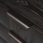 A softened Brutalist take on the traditional nightstand. The monolithic piece’s black oak veneer case sits atop a matching pedestal for an element of exaggeration. A grid pattern with inflated volume adds drama.As enthusiasts of luxe materials at Amethyst, we love the warm modern inspired Swell Nightstand - Dry Black Oak Veneer. Amethyst Home provides interior design, new home construction design consulting, vintage area rugs, and lighting in the San Diego metro area.