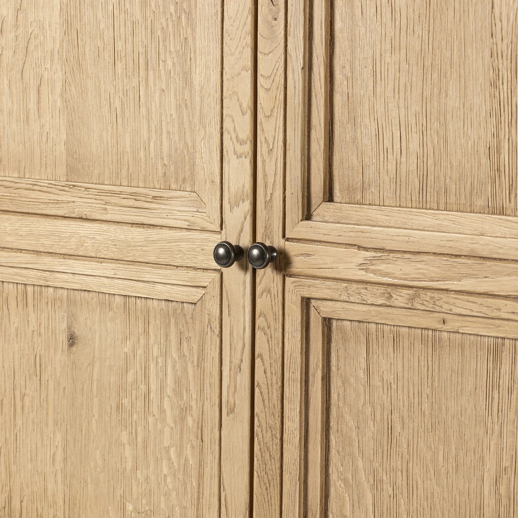 Worn oak cabinetry with paneled doors, all atop an elevated stand. With natural cracks for character, this piece can be styled just about anywhere, bringing with it bonus storage and vintage charm.Collection: Cordell Amethyst Home provides interior design, new home construction design consulting, vintage area rugs, and lighting in the Kansas City metro area.