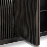 Bring a truly unique look to the dining or living space with this stunning sideboard inspired by rolling ocean tides. Crafted of solid mindi and mindi veneer, a stunning front features repetitive, flow-like reeding that's been precision-cut in individual pieces and assembled onto the doors, creating deep curves reminiscent of rippling waves. Amethyst Home provides interior design, new home construction design consulting, vintage area rugs, and lighting in the Los Angeles metro area.