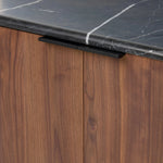 Design your space with hallmark features inspired by soft Brutalism. Made from solid walnut and poplar woods with a natural finish, the cabinet is topped with a black marble top with half bullnose edging for smooth contours. Double doors open to two shelves for ample storage. High-quality hardware is crafted from black iron. Amethyst Home provides interior design, new home construction design consulting, vintage area rugs, and lighting in the Tampa metro area.