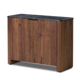 Design your space with hallmark features inspired by soft Brutalism. Made from solid walnut and poplar woods with a natural finish, the cabinet is topped with a black marble top with half bullnose edging for smooth contours. Double doors open to two shelves for ample storage. High-quality hardware is crafted from black iron. Amethyst Home provides interior design, new home construction design consulting, vintage area rugs, and lighting in the Washington metro area.