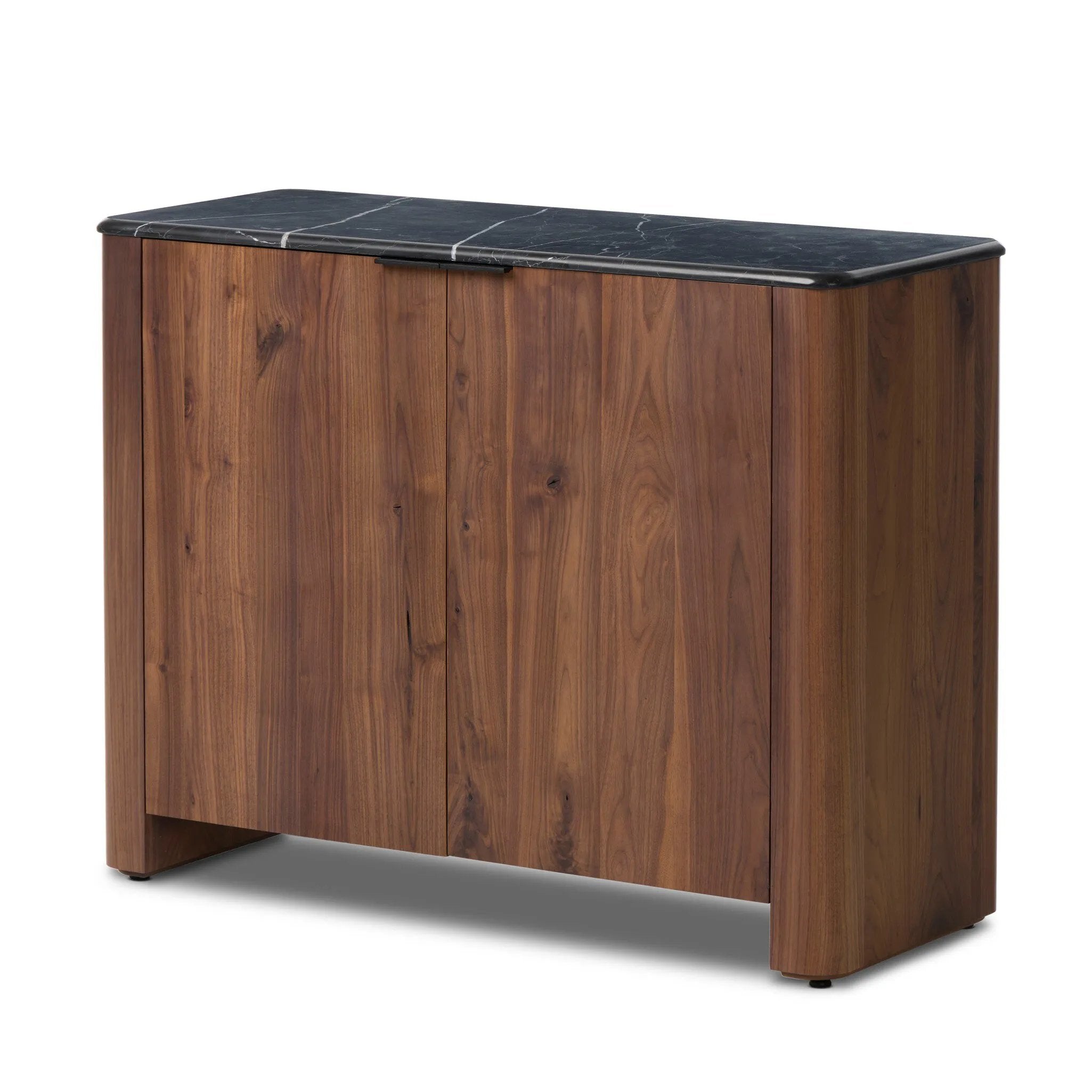 Design your space with hallmark features inspired by soft Brutalism. Made from solid walnut and poplar woods with a natural finish, the cabinet is topped with a black marble top with half bullnose edging for smooth contours. Double doors open to two shelves for ample storage. High-quality hardware is crafted from black iron. Amethyst Home provides interior design, new home construction design consulting, vintage area rugs, and lighting in the Washington metro area.