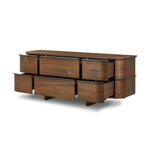 Dark brown walnut is aesthetically shaped with fluid, rounded corners on a ski leg base. The seamless design features six spacious drawers with metal bar hardware that runs along the tops of the drawers Amethyst Home provides interior design, new home construction design consulting, vintage area rugs, and lighting in the Newport Beach metro area.