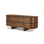 Dark brown walnut is aesthetically shaped with fluid, rounded corners on a ski leg base. The seamless design features six spacious drawers with metal bar hardware that runs along the tops of the drawers Amethyst Home provides interior design, new home construction design consulting, vintage area rugs, and lighting in the Portland metro area.