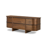 Dark brown walnut is aesthetically shaped with fluid, rounded corners on a ski leg base. The seamless design features six spacious drawers with metal bar hardware that runs along the tops of the drawers Amethyst Home provides interior design, new home construction design consulting, vintage area rugs, and lighting in the Portland metro area.