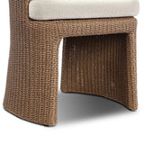 This outdoor dining chair takes on a curved silhouette, crafted from woven faux hyacinth and complemented by a heavily textured boucle cushion. Cover or store inside during inclement weather and when not in use.As lovers of natural materials at Amethyst, we love the designer inspired Thora Outdoor Dining Chair - Vada Cream. Amethyst Home provides interior design, new home construction design consulting, vintage area rugs, and lighting in the Dallas metro area.