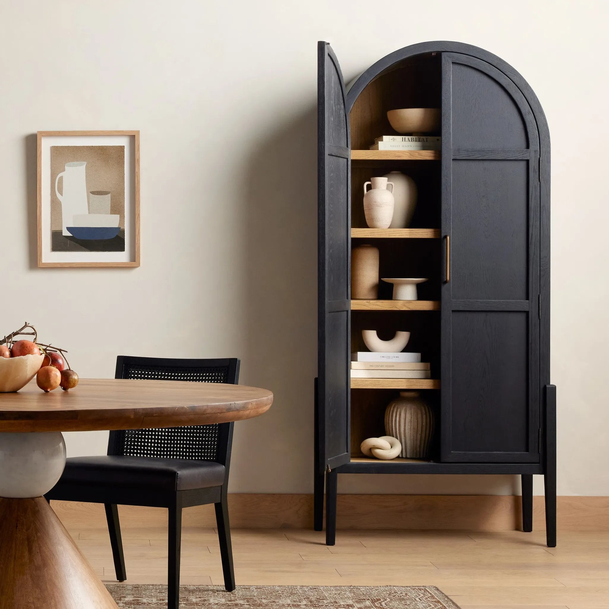 Store it in style. Beautifully shaped cabinetry in drifted matte black veneer features spacious interior shelving and recessed wood panel doors, ready for storing your treasures Amethyst Home provides interior design, new home construction design consulting, vintage area rugs, and lighting in the Des Moines metro area.