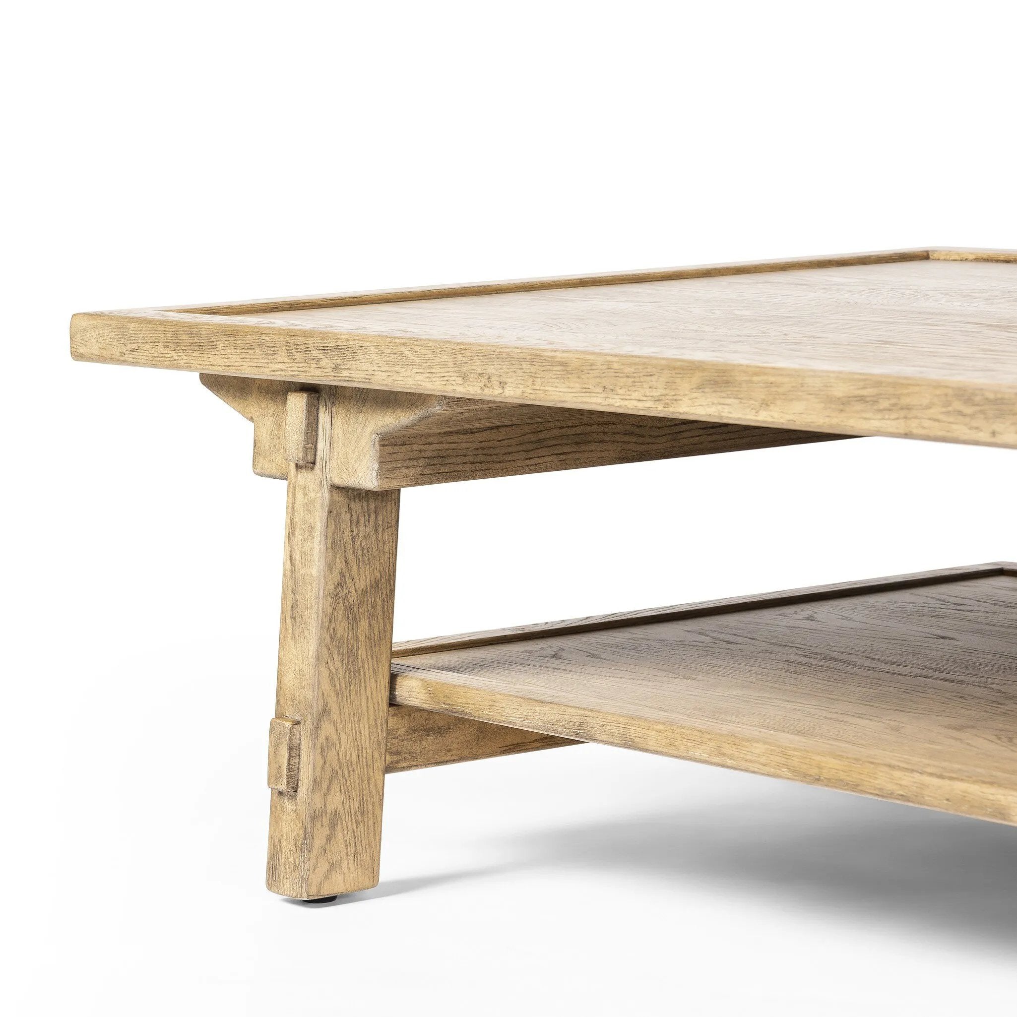 Featuring Trinity Distressed Light Oak Coffee Table by Four Hands at Amethyst Home. This Asian-inspired design made from light, distressed oak features mortise-and-tenon joinery, which connects protruding stretchers to sturdy legs. Lower shelving for bonus storage and display.Overall Dimensions: 65.00"w x 35.50"d x 16.00"hWeight : 127.87 lbsMaterials : Soli. Amethyst Home provides interior design, new home construction design consulting, vintage area rugs, and lighting in the Charlotte metro area.