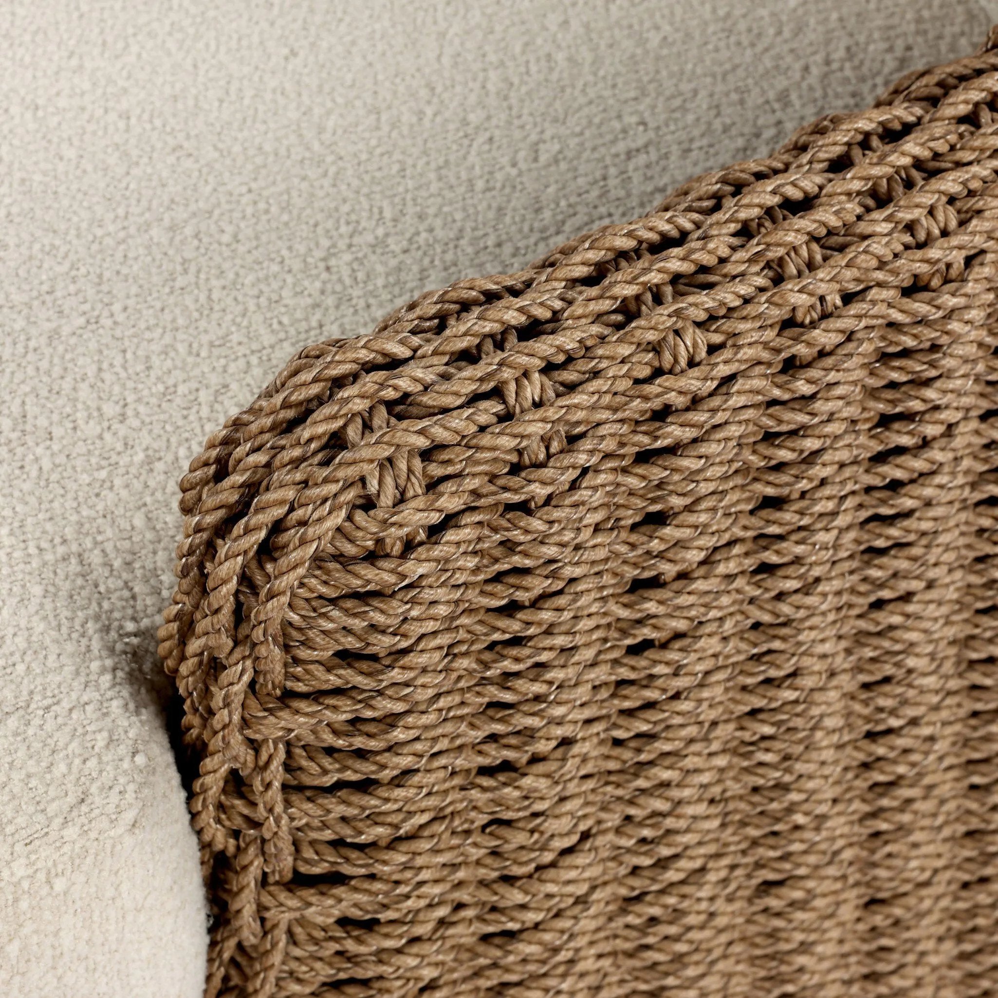 This outdoor chair's sculpted shape mimics classic wingback armchairs, with a double-twist woven material framing heavily textured boucle fabric for added visual weight. Cover or store inside during inclement weather or when not in use. Amethyst Home provides interior design, new home construction design consulting, vintage area rugs, and lighting in the Boston metro area.
