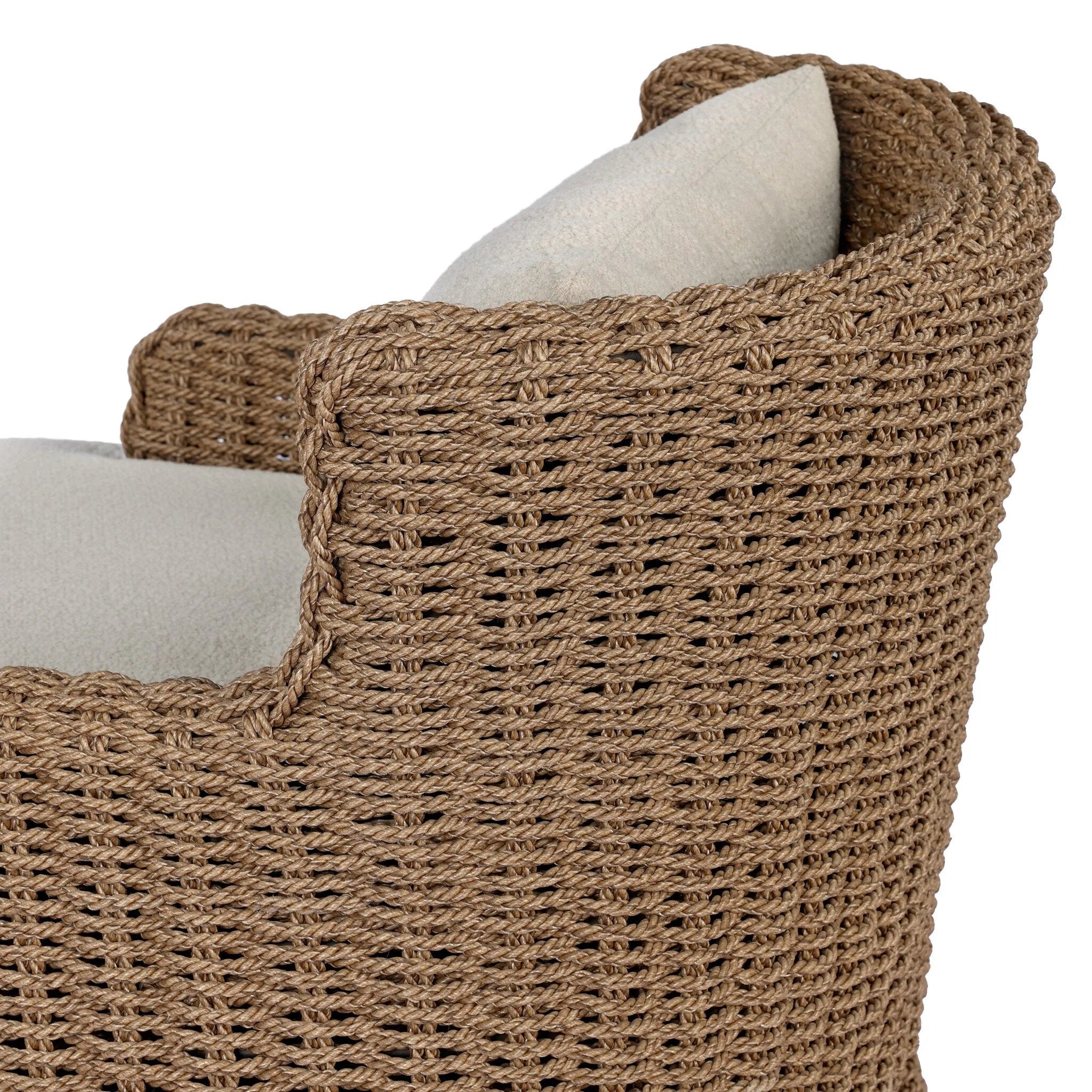 This outdoor chair's sculpted shape mimics classic wingback armchairs, with a double-twist woven material framing heavily textured boucle fabric for added visual weight. Cover or store inside during inclement weather or when not in use. Amethyst Home provides interior design, new home construction design consulting, vintage area rugs, and lighting in the Monterey metro area.