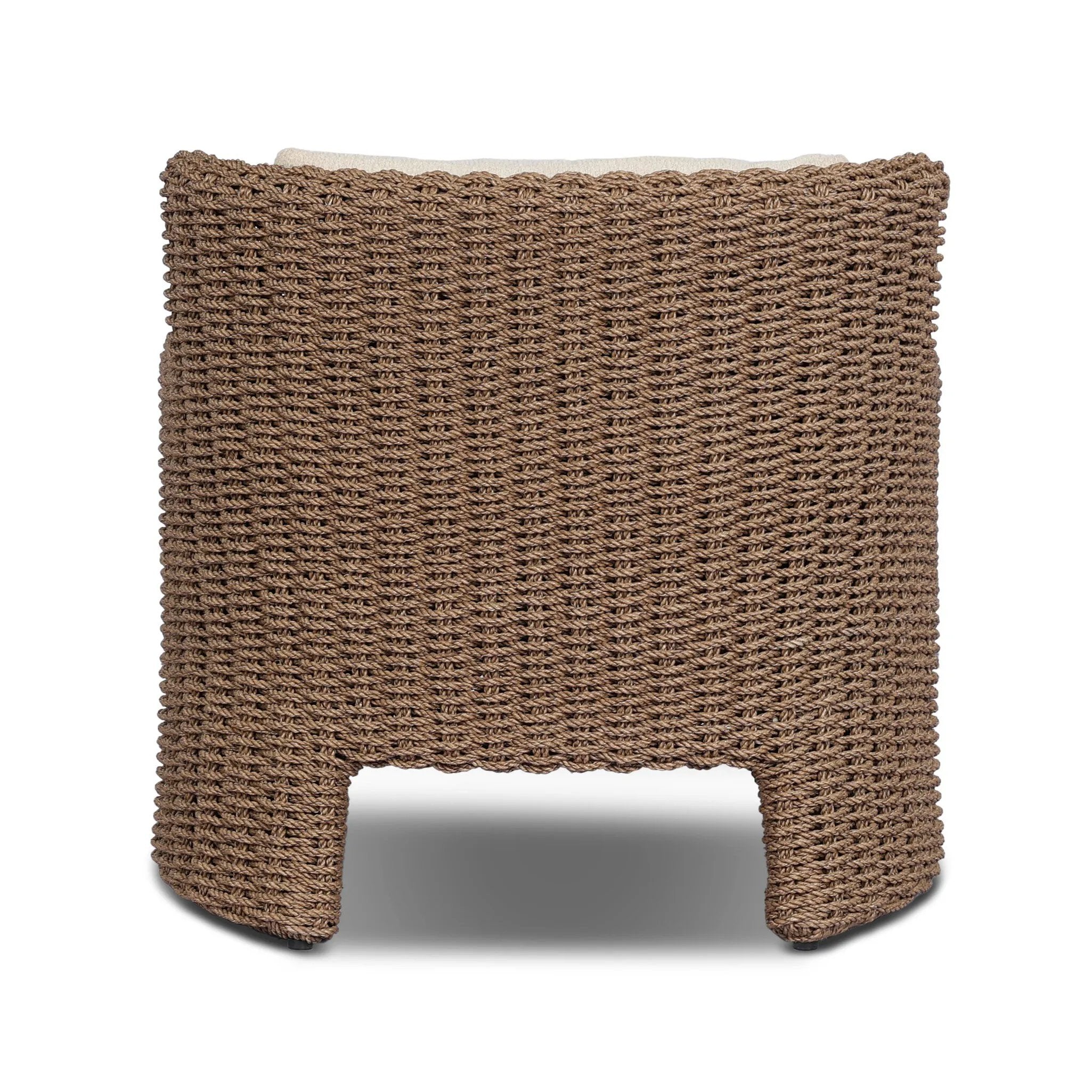 This outdoor chair's sculpted shape mimics classic wingback armchairs, with a double-twist woven material framing heavily textured boucle fabric for added visual weight. Cover or store inside during inclement weather or when not in use. Amethyst Home provides interior design, new home construction design consulting, vintage area rugs, and lighting in the San Diego metro area.